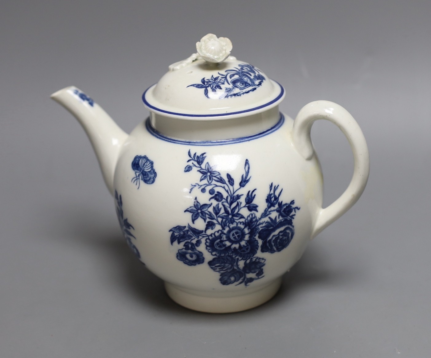 A Caughley teapot and cover printed in underglaze blue with the Three Flowers pattern, S mark in blue to base, 17 cms high